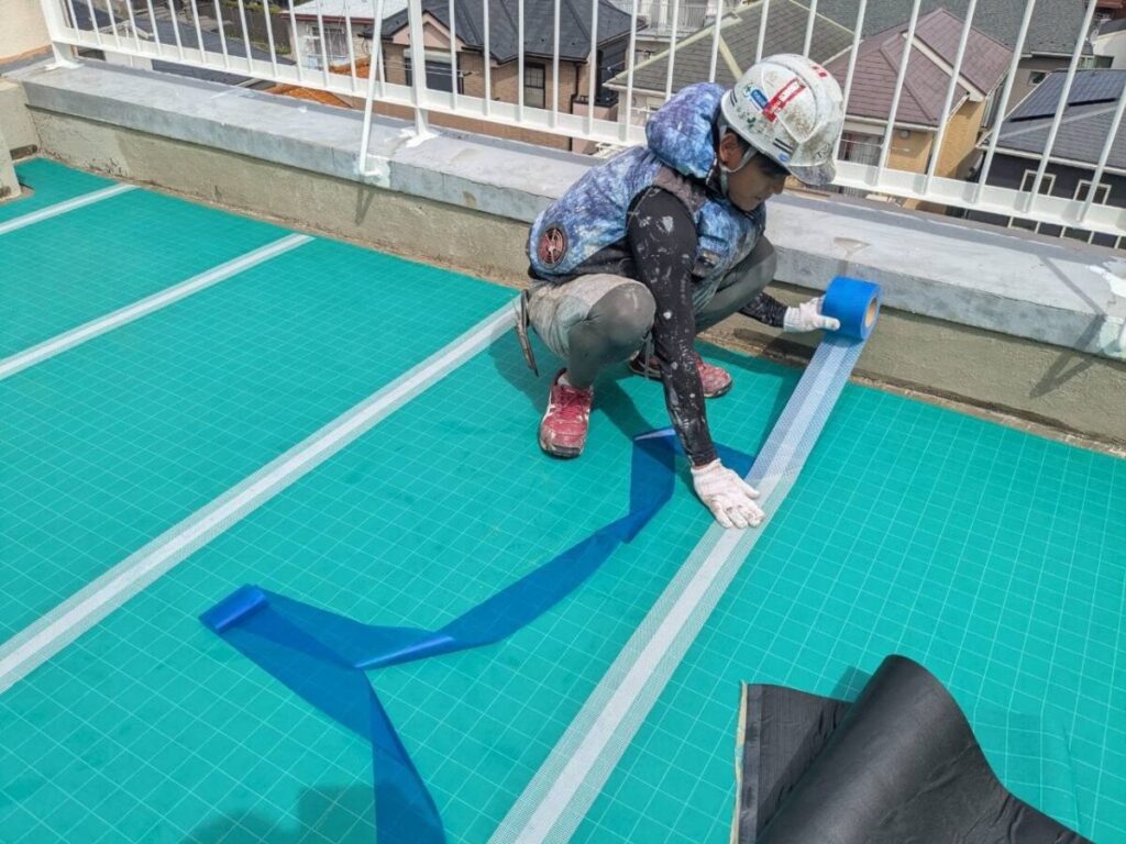 通気シートの継ぎ目へ、専用のジョイントテープを施工します。